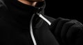 Blank black fleece jacket zipper pulled up, isolated front view Royalty Free Stock Photo