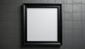 A blank black-framed picture frame mounted on a textured gray wall. The frame is empty, providing a minimalist aesthetic Royalty Free Stock Photo