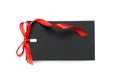 Blank black gift tag with red satin ribbon on white background, top view. Space for design Royalty Free Stock Photo