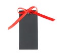 Blank black gift tag with red satin ribbon on white background, top view. Space for design Royalty Free Stock Photo