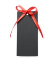 Blank black gift tag with red satin ribbon on white background, top view. Space for design Royalty Free Stock Photo