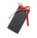 Blank black gift tag with red satin ribbon on white background, top view. Space for design Royalty Free Stock Photo