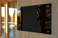 Blank black glass signboard on wall mockup. Empty hanging plexiglass name plate mockup. Clear dark namesign on wall for Royalty Free Stock Photo