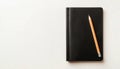 Blank Black Leather Diary And Pencil On White Desk Seen From Above: A Stylish And Organized Workspace Setting. Royalty Free Stock Photo