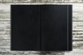 Blank black notepad on wooden desktop