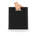 Blank black paper bag mock up holding in hand. Empty plastic pac