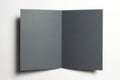 Blank black paper opened bi-fold flyer brochure isolated on white as template for design presentation, greeting cards, event