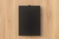 Blank black paper poster hanging on binder clip Royalty Free Stock Photo