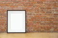 Blank black picture frame on the red brick wall and the wooden floor, template poster interior photo 3d background Royalty Free Stock Photo