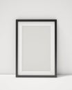 Blank black picture frame on the white interior background Royalty Free Stock Photo