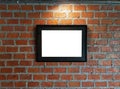 Blank black picture frames are mounted on red brick walls with c Royalty Free Stock Photo