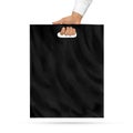 Blank black plastic bag mock up holding in hand. Empty polyethyl