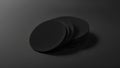 Blank black round beer coasters stack mockup on dark surface, depth of field, 3d rendering. Empty cardboard disk pile