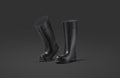 Blank black rubber wellington boots mockup, dark background