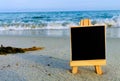 Blank black signboard on the beach. Royalty Free Stock Photo
