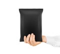 Blank black snack bag mock up hold in hand isolated.