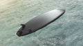 Blank black surfboard with fins on water surface mock up