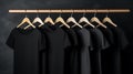 Blank black t-shirts set hanging on hangerâs mockup dark black background Royalty Free Stock Photo