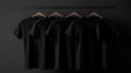 Blank black t-shirts set hanging on hangerâs mockup dark black background Royalty Free Stock Photo