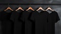 Blank black t-shirts set hanging on hangerâs mockup dark black background Royalty Free Stock Photo