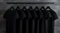 Blank black t-shirts set hanging on hangerâs mockup dark black background Royalty Free Stock Photo