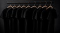 Blank black t-shirts set hanging on hangerâs mockup dark black background Royalty Free Stock Photo