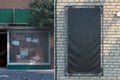 Blank Black Vertical Outdoor Vinyl Textile Banner at Bright Brick Wall. Copy Space. Empty Space.