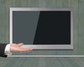 Blank black wide flat TV screen hanging on wooden wall