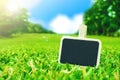 Blank Blackboard clip on green grass fielda and sunlight with bl Royalty Free Stock Photo