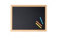 Blank blackboard with colored chalks