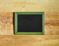Blank blackboard in frame on wooden background Royalty Free Stock Photo