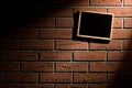 Blank blackboard hanging on brick wall Royalty Free Stock Photo