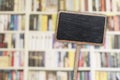 Blank blackboard label and blurred library in the background Royalty Free Stock Photo