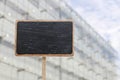 Blank blackboard label and a glass corporate building in the background Royalty Free Stock Photo