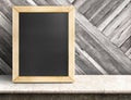 Blank blackboard on marble table at diagonal wooden wall,Template mock up for adding your design and leave space beside frame for Royalty Free Stock Photo