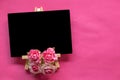 blank blackboard and pink flower on pink background with copy space, Valentines Day concept Royalty Free Stock Photo
