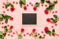 Blank blackboard surrounded with red roses and hearts on pink Valentines day background. Birthday, Mother`s, women`s day Royalty Free Stock Photo