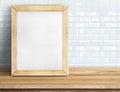 Blank blackboard on tropical wooden table at white tile wall,Template mock up for adding your design and leave space beside frame Royalty Free Stock Photo