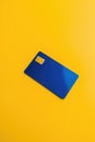 Blank blue credit card with microchip on yellow, copy space, created using generative ai technology Royalty Free Stock Photo