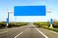 Blank blue freeway sign over the road on sunny day Royalty Free Stock Photo