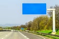 Blank blue freeway sign over the road on sunny day Royalty Free Stock Photo