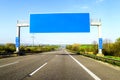 Blank blue freeway sign over the road on sunny day Royalty Free Stock Photo