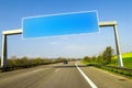 Blank blue freeway sign over the road on sunny day Royalty Free Stock Photo