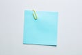 Blank blue note paper or notepad with a yellow paper clip on white background with copy space Royalty Free Stock Photo