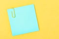 The Blank blue notes paper with a paper clip on yellow background, for your text or message Royalty Free Stock Photo