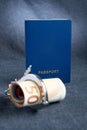 Blank blue passport background on gray background with from the euro in handcuffs. the concept lack of money for travel