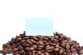 Blank blue post-it paper on pile of roasted coffee beans Royalty Free Stock Photo