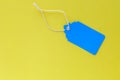 Blank blue sale tag mock up isolated on bright yellow background