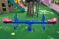 Blank blue teeterboard on the kids playground in garden