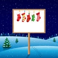 Blank board on winter night with christmas socks